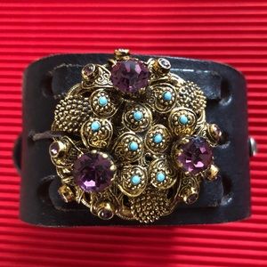 Upcycled black leather cuff with antique brooch.